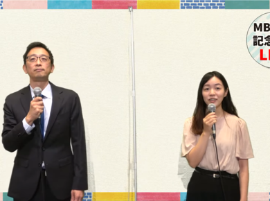 two young Asian people speak into microphones