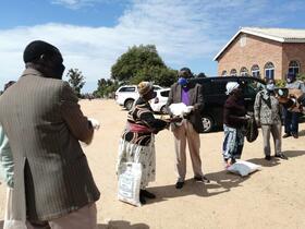 line of people hand over relief supplies